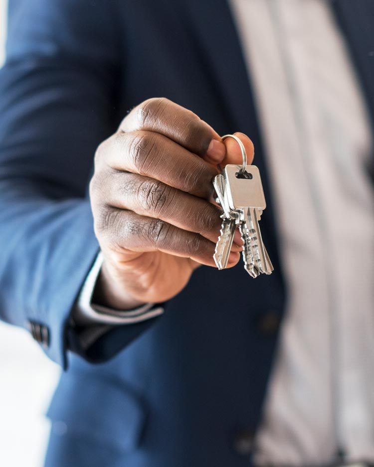 Real estate agent holding house keys